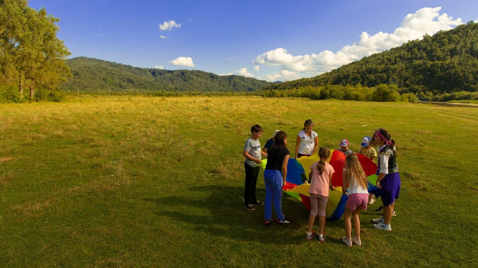 group of people standing on green grass field during daytime